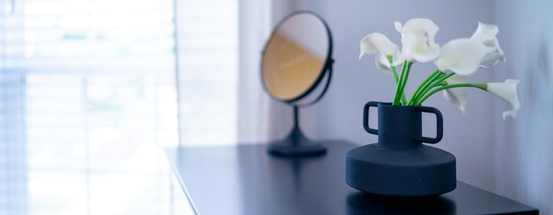 a vase with white flowers on a table