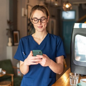 a person holding a phone in a coffee shop