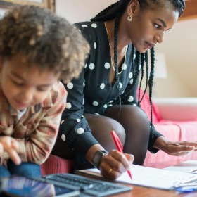 a person and a child writing